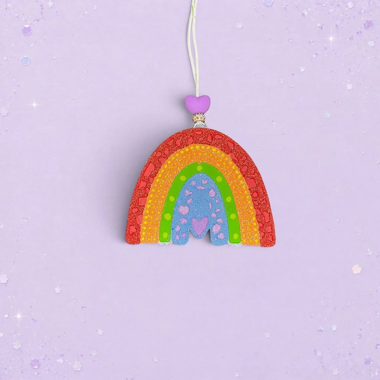 BeFreshie textured rainbow car freshie in vibrant colors with a purple heart bead on a light purple background