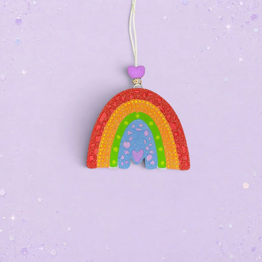 BeFreshie textured rainbow car freshie in vibrant colors with a purple heart bead on a light purple background